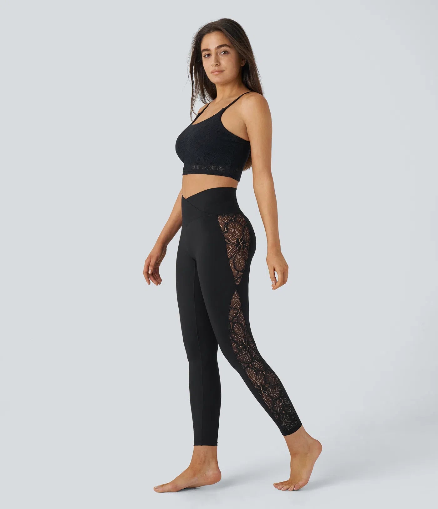 Woman wearing FEMORA crossover lace yoga leggings
