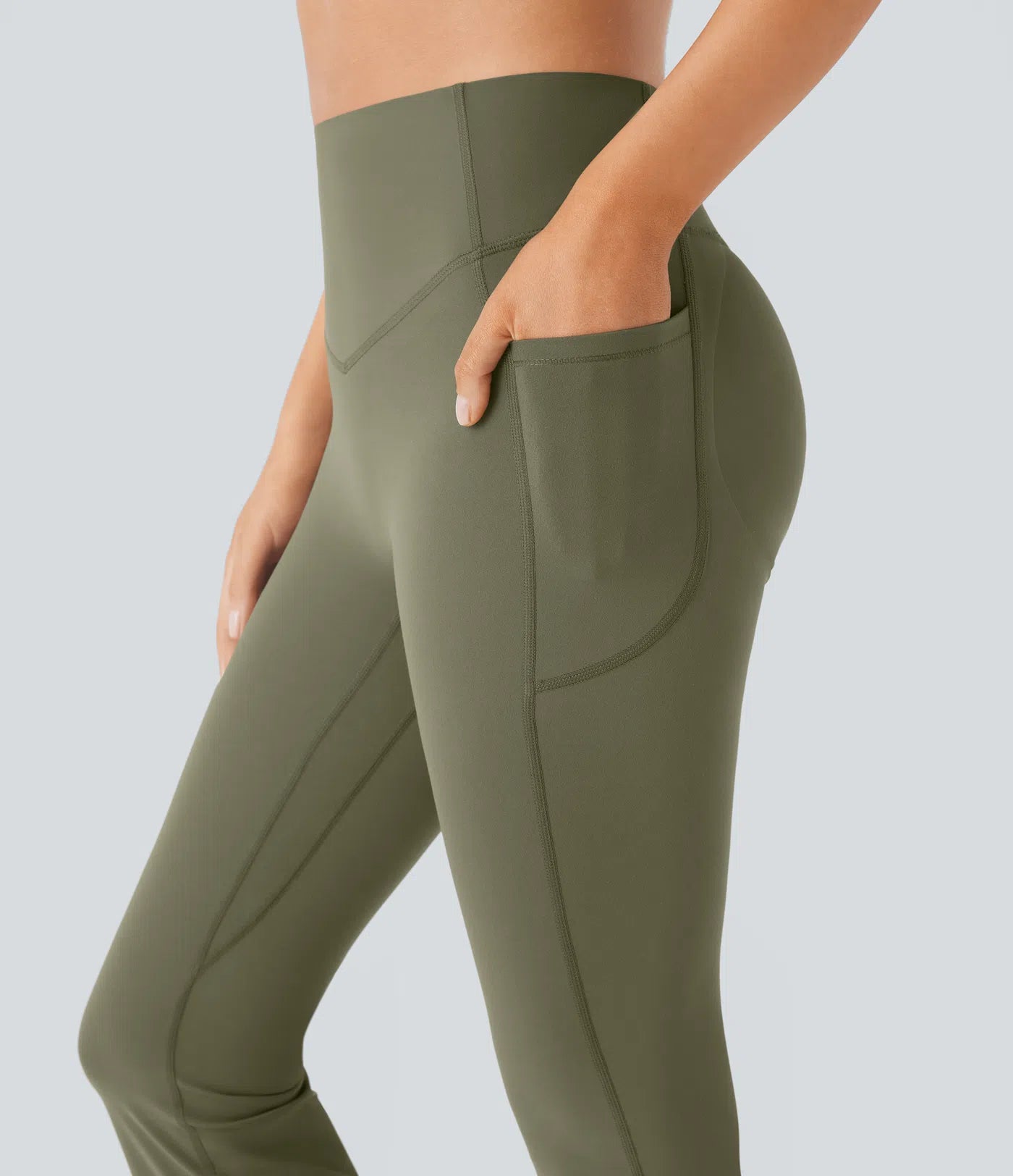 Side view of FEMORA high waisted bootcut leggings with pockets
